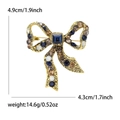 Spilla a fiocco dorata con cristallo blu e strass, dimensioni 4,9 cm x 4,3 cm - Blu