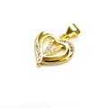 Close-up of golden heart pendant with shimmering zircon pavé inlay and polished frame - Letter V