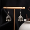 Detail of vintage silver Jhumka earrings with bell shape and floral carving on black silk - H4413 Antique Silver