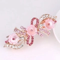 Rose gold hair clip with pink resin flowers and sparkling crystals on pink background - Large 3 Flowers Pink