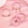 Detailed view of pink pearl bracelets with pink ribbon charms for awareness - Pink Ribbon Multi-Style Bracelet Set (Set of 4)