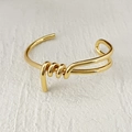 Polished gold-plated brass open bangle featuring a unique knotted twist design - Style D (Single Line Knot)