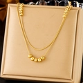 Detail of double-layer gold beaded snake chain necklace on a beige jewelry display box - Gold Double Layer Bead Necklace (N2799 Gold)