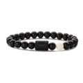 Detail of Aquarius zodiac bracelet with polished black beads and white stone accent - Aquarius Opal