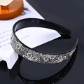 Sparkling black rhinestone headband with internal grip teeth on reflective surface - Three-Leaf Transparent Grey
