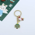 Detailed view of Christmas keychain with Santa Claus and tree charms on festive card - Christmas Tree and Santa Claus