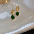 Vintage gold hoop earrings featuring oval emerald green gemstones on white silk - Emerald Green Oval Pendant Ear Buckle