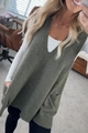 Detail view of olive green V-neck knitted vest with thick ribbed texture in home setting - S / Dark Green