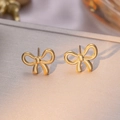 Polished golden bow-shaped titanium steel stud earrings with a refined mirror finish - Bowknot Stud Earrings / Gold