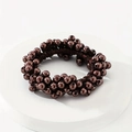 Close-up of coffee brown pearl beaded hair tie with metallic luster on white display stand - Coffee