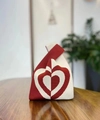Detailed view of red and white striped knit bucket bag with heart pattern on wood surface - Spliced Heart