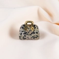 Mini Dalmatian Jasper gemstone handbag pendant with golden handle on beige fabric - Dalmatian Jasper