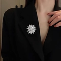 Elegant silver snowflake brooch with sparkling crystals pinned to a black suit lapel - Silver Rhinestone Snowflake (E32051-1)