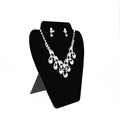 Silver jewelry set with rhinestones and pearls displayed on a black bust stand - Black Portrait Display Plate
