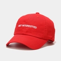 Detail shot of white 'NOT INTERESTED' embroidery on a red cotton baseball cap crown - M(56-58cm) / Red