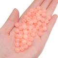 Pink round glass jelly beads for DIY handmade jewelry crafting shown on hand - Apricot approx 50pcs/pack