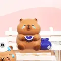 Capybara resin figurine with blue bag and teary eyes on white mini bench - Workplace Theme Capybara (3087) / Ornament Series