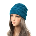 Minimalist knit beanie in deep teal for women, warm winter ribbed hat on display - Teal