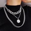 Silver multi-layered necklace featuring chunky cuban links and relief coin pendant on model - Silver