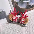 Red velvet reindeer antler hair clips with miniature Santa Claus figures for Christmas - Red Antlers With Santa Claus Pair