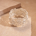 Dettaglio del bracciale argento con texture floreale a rilievo e bordi geometrici - Argento