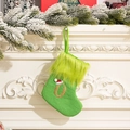 Green knitted Christmas stocking with a golden letter O and a mini Santa hat decoration - Letter O