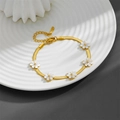 Macro shot of gold daisy butterfly snake chain bracelet with white shell flower details - White Shell Chrysanthemum Bracelet (N302) / Gold