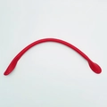 Macro view of red leather handbag strap with pre-punched stitching holes for DIY craft - Red