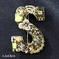 Golden S-shaped brooch with white pearls, green crystals, and colorful rhinestones - Letter S