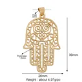 Detailed view of gold Hamsa hand pendant with heart cutout and 39mm x 26mm dimensions - M599354-gold / Gold