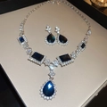 Detailed shot of teardrop blue gemstone necklace and earrings set in a beige box - 7# Water Drop Blue Gem - Silver (2-Piece Set)