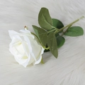 Single white velvet artificial rose with green leaves on white plush background - White