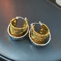 Close-up of two-tone hoop earrings featuring unique hammered texture on gold and silver metal - Gold-Silver Double-Layer Hoop