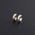 Detailed macro view of brushed titanium steel hoop earrings in silver and gold finish - Frosted Gold and Silver