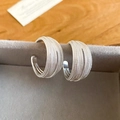 Detailed macro view of silver multi-layer woven C-shaped stud earrings on a velvet box - Multi-Layer Braided Texture C-Hoop (59#)