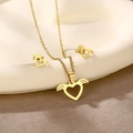 Detail of gold winged heart jewelry set on a white ceramic plate with soft lighting - Winged Heart (TZ-420)