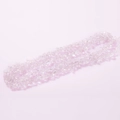 Irregular clear white crystal quartz chips for DIY jewelry on a soft pink background - Clear