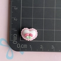 Macro shot of 1.5cm heart resin charm with cherry detail on a black scale mat - Pink Wavy Heart with Flowers / Mini Small