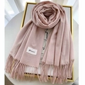 Detail shot of soft pale pink cashmere scarf with fringe edges and brand label - Light Pink