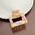 Elegant white marble acetate square claw clip for women on a rustic wood surface - 5.2cm / Amber White