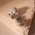 Detail of silver C-shaped stud earrings with hammer texture on a stone background - Steel Earring Post / Silver