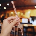 Detail of pink marble acetate hair pin with unique spiral twist design held in hand - 9# Nude Pink Marble