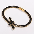 Close-up of gold tennis bracelet featuring black zircon stones and cross charm detail - Gold Black Zirconia