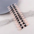 Detailed view of French-style ballerina fake nails with nude base and black tips on marble - French Black Tip Long Coffin Matte (CFX-MP02)