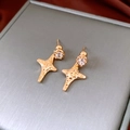Detailed macro view of 18K gold plated star earrings with clear zircon stones on a jewelry box - Gold (925 Sterling Silver Earring Post)