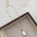 Detail shot of a rectangular baroque pearl pendant on a gold beaded chain necklace - Single Baroque Pearl Necklace