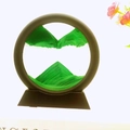 Round sand art decor with green flowing liquid sand and black frame on a base - 5 Inch Round Green