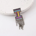 Detailed view of colorful woven brooch featuring hanging rhinestone fringes on ceramic - Letter I