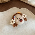Close-up of handmade wool felt girl brooch with colorful beads on a linen background - Brown and White Flower Girl / Coffee/White