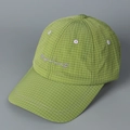 Close-up of green checkered baseball cap with purple Magical secrets embroidery - Yellow-Green